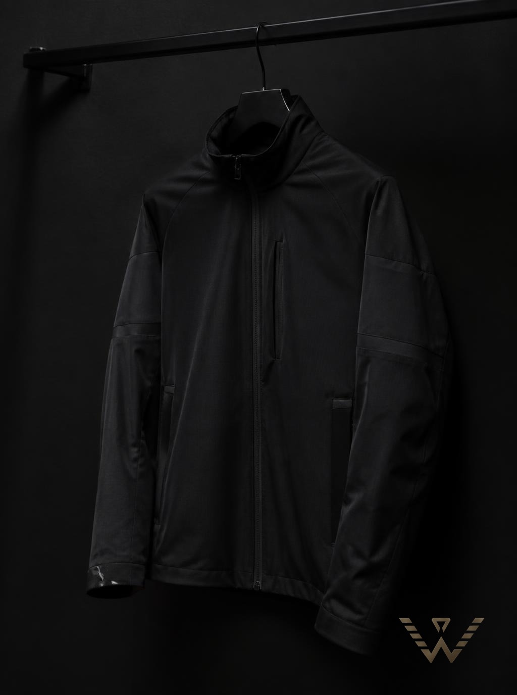 Black technical shell jacket on a rail